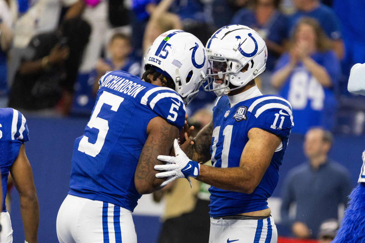 Sep 10, 2023; Indianapolis, Indiana, USA; Indianapolis Colts wide receiver Michael Pittman Jr. (11) gives his touchdown ball to quarterback Anthony Richardson (5) after scoring his first passing touchdown in the second half against the Jacksonville Jaguars at Lucas Oil Stadium.